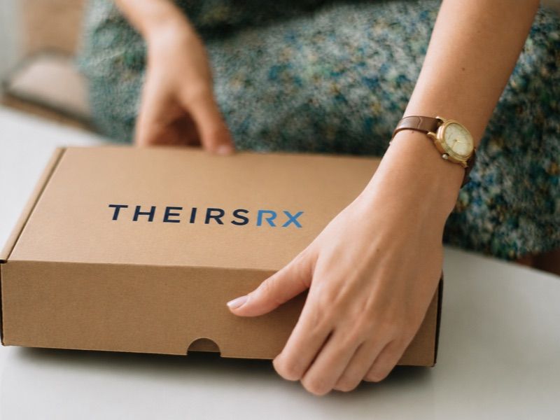 Member opening a Theirsrx medication delivery box
