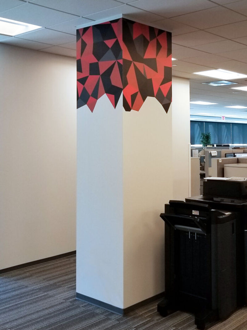 Amplify Wallcovering column wrap signage in graphic & red (Traffic; heavyweight, self-adhesive vinyl material) done for Navy Federal Credit Union.
