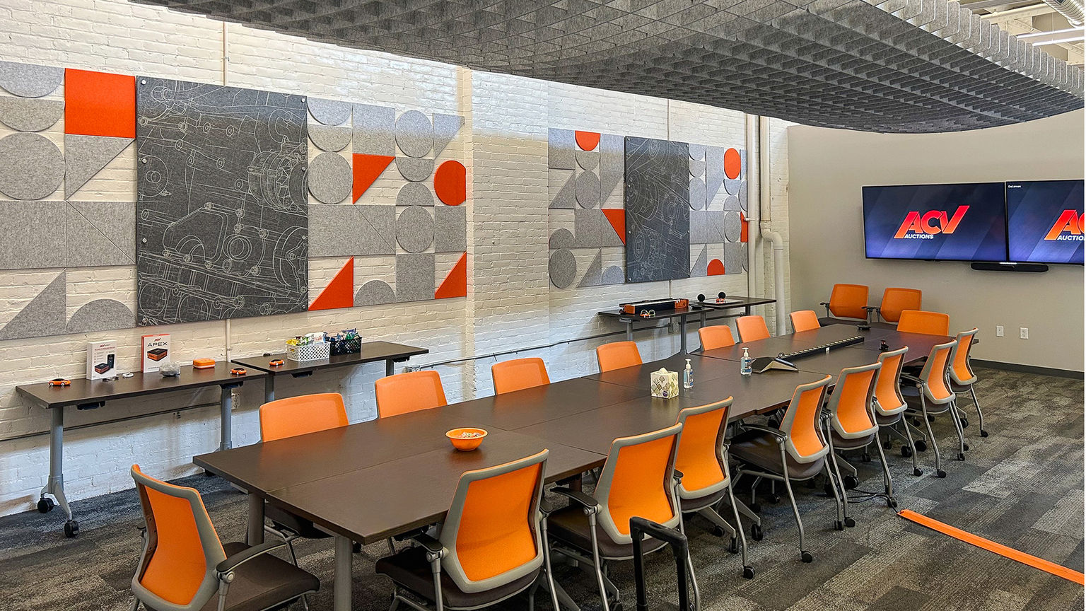 A conference Room with custom printed acoustic panels and an acoustic tile pattern made up of various sahpes and colors.