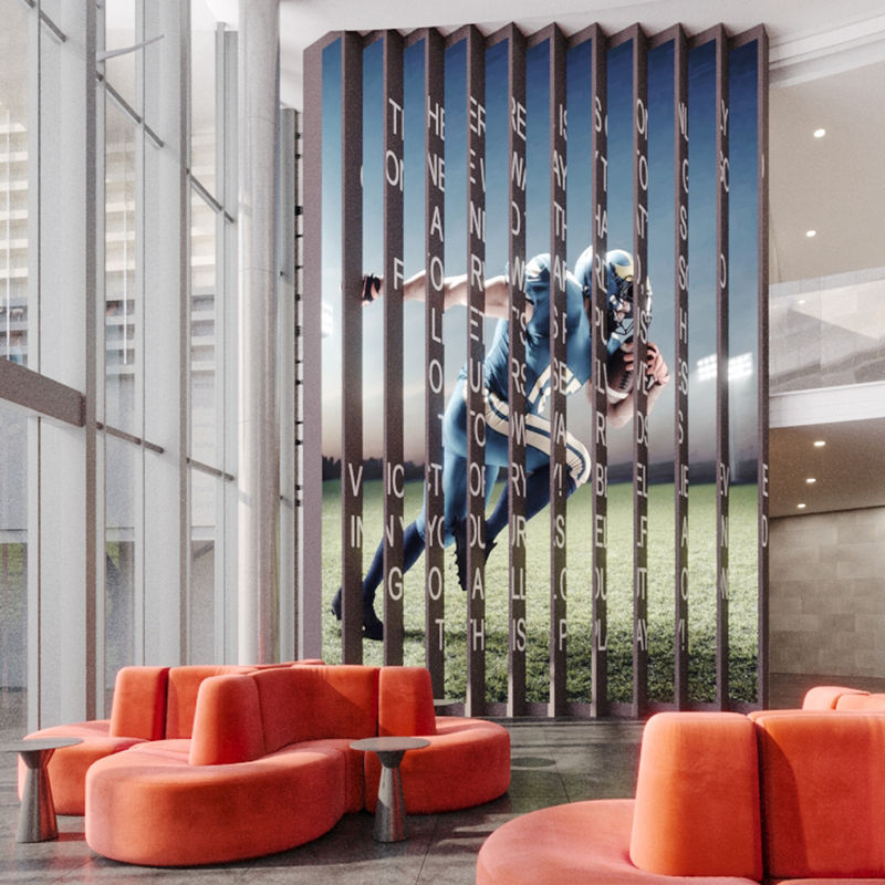 Custom wallcovering installation installed to create a lenticular effect. From one viewpoint, a running football player; from the opposite view, a motivational quote displays.