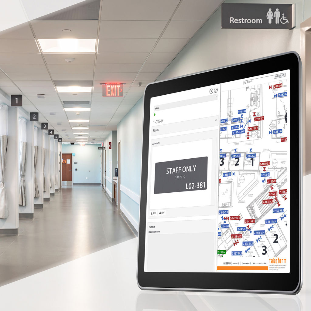 Hosptal corridor and tablet with sign system management application on screen.