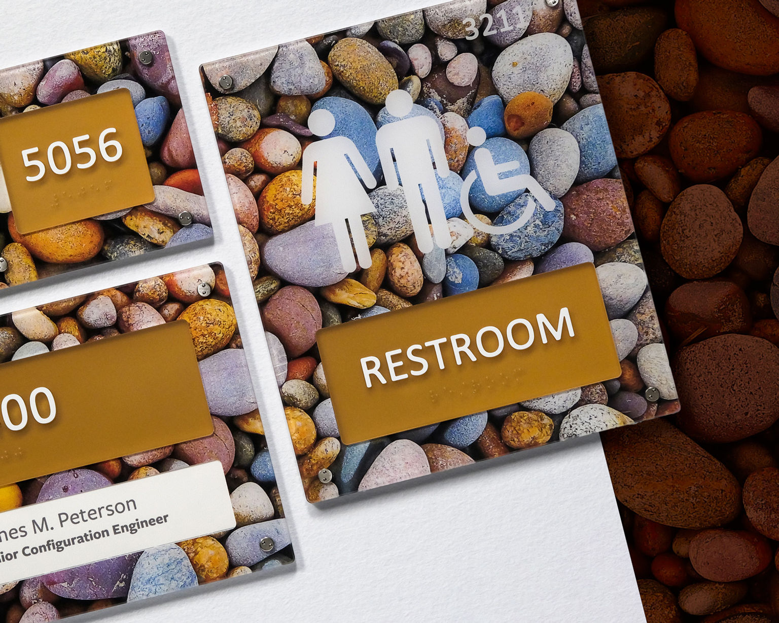 A family of ADA compliant room ID signs custom printed with a calming colorful river rock photo.