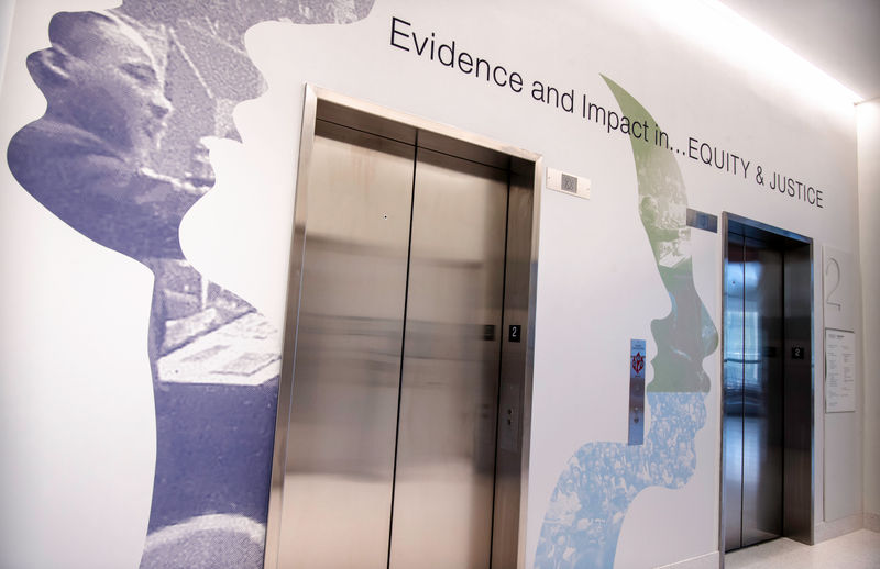 Elevator banks covered organic themed wallcevering with inspirational quote.