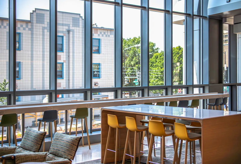University's student lounge features window film on floor to ceiling windows with inspiring messages that inspire school's mission.