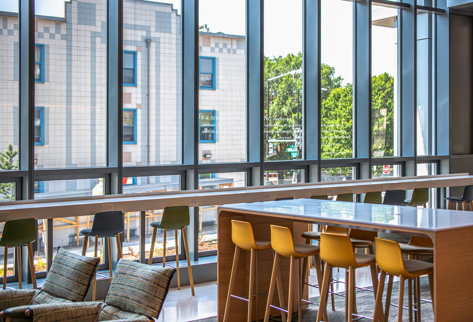 A contemporary student lounge with inspirational quotes applied to the windows with amplify window film.