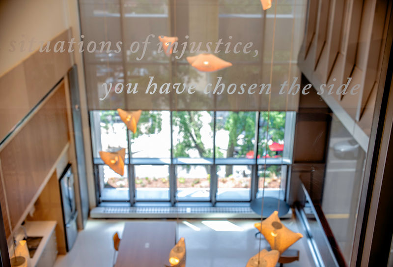 Detail of custom cut opaque window lettering applied to a glass window.