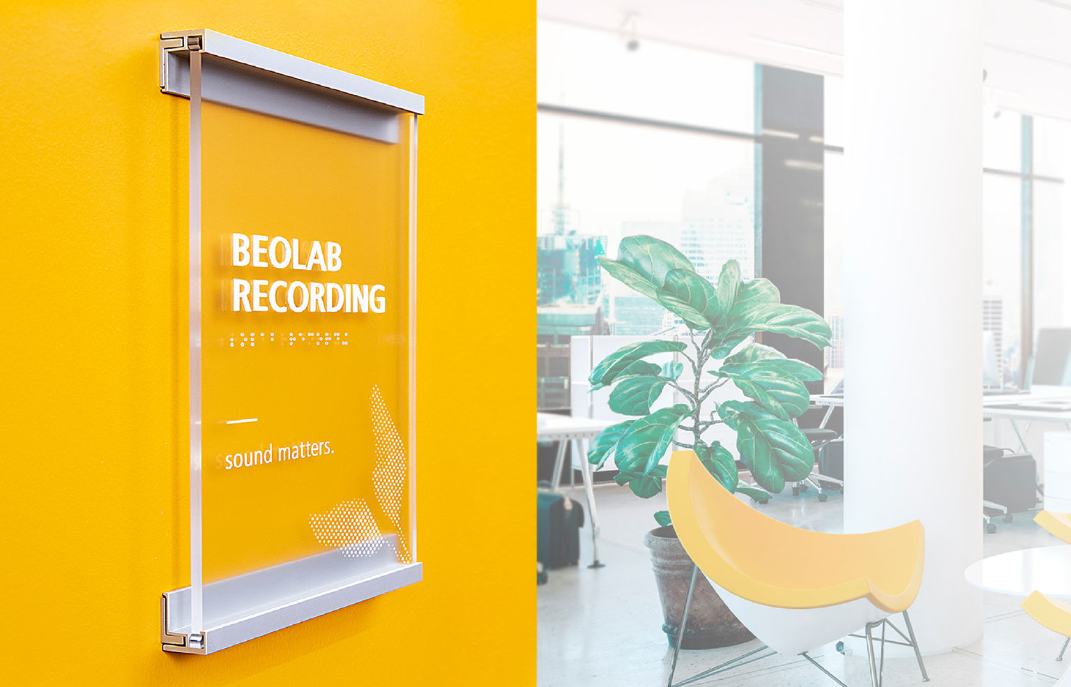 An ADA-compliant minimalist metal and glass-look recording studio room sign on a vibrant orange wall; a modernist lounge is visible in the background.