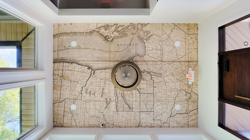 Amplify custom wallcovering applied to the foyer ceiling custom printed with a historic map of the area.