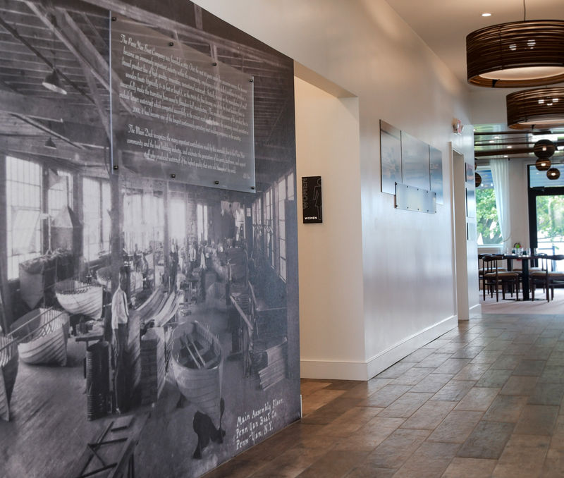 A large Amplify wallcovering and acrylic display of the manufacturing floor of the original Penn Yann factory.