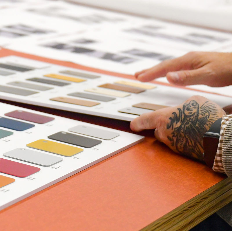 Designers reviewing various laminate finishes to ensure color and brand consistancy.