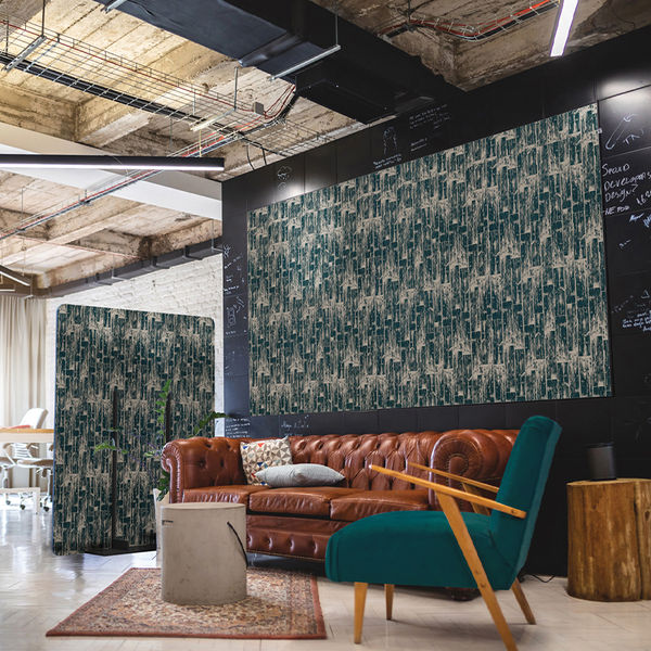 An eclectic office space featuring custom-printed acoustic wall panels and freestanding partitions in a lounge seating area.