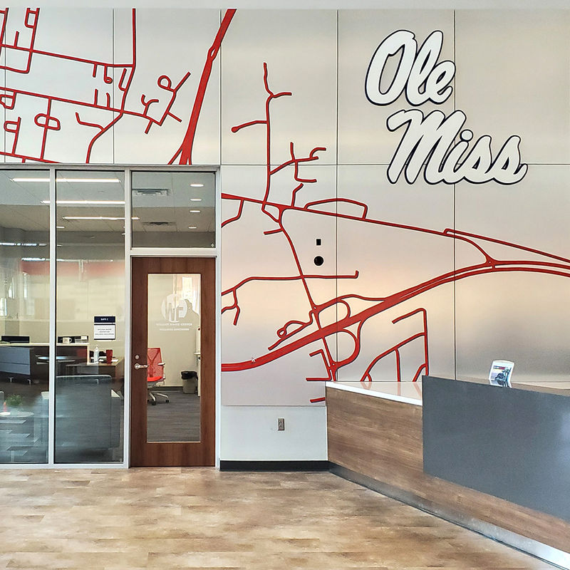 Branded Ole Miss graphic panel installation surrounding the Wellness Education Center office on the University of Mississippi campus.