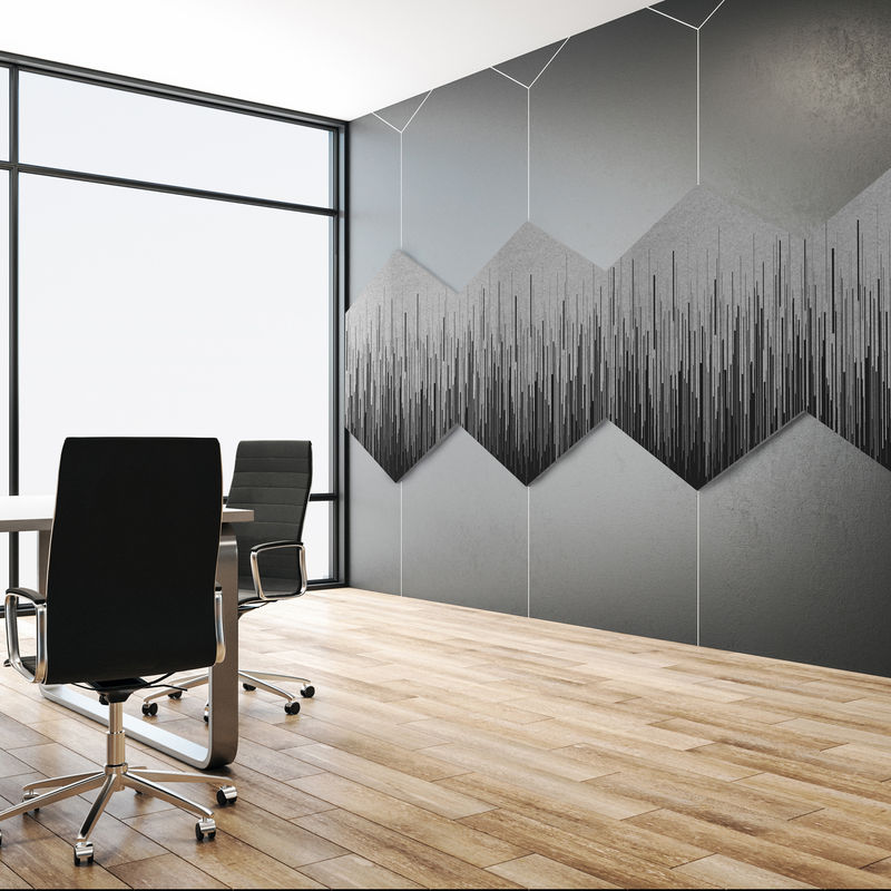 Large hexagon-shaped gray acoustic panels with custom printing in a contemporary conference room.