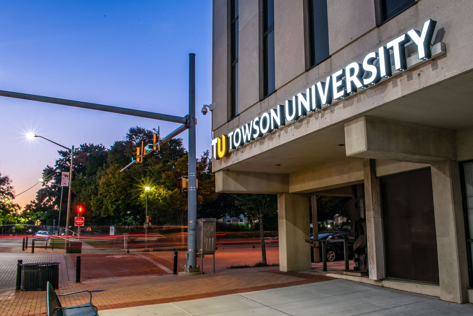 Illuminated Ethos dimensional letters installed on the exterior facade of a college downtown building.