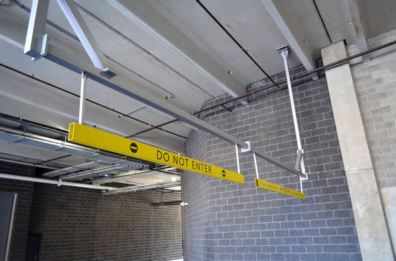 Transit Parking Garage Signage. Suspended Overhead Break-Away Bang Bars.