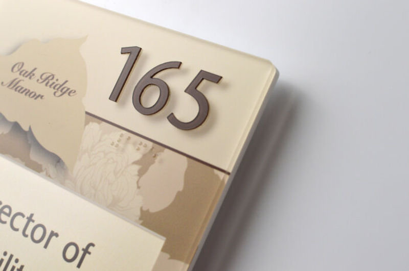 Vivid Room ID Interior Signage with Espresso raised copy set in the typeface Sanstone. 