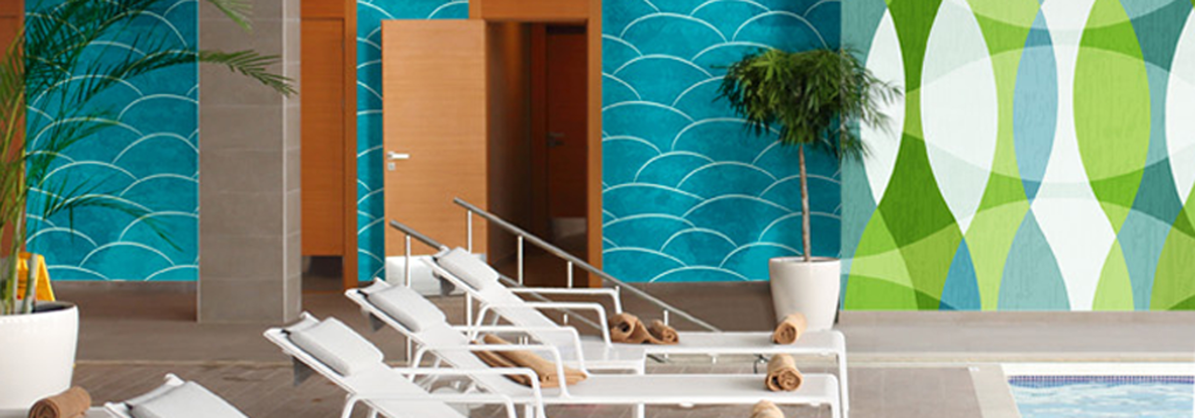 Wall to wall Amplify wallcovering in a hotel pool with bright colorful nautical themed graphics.