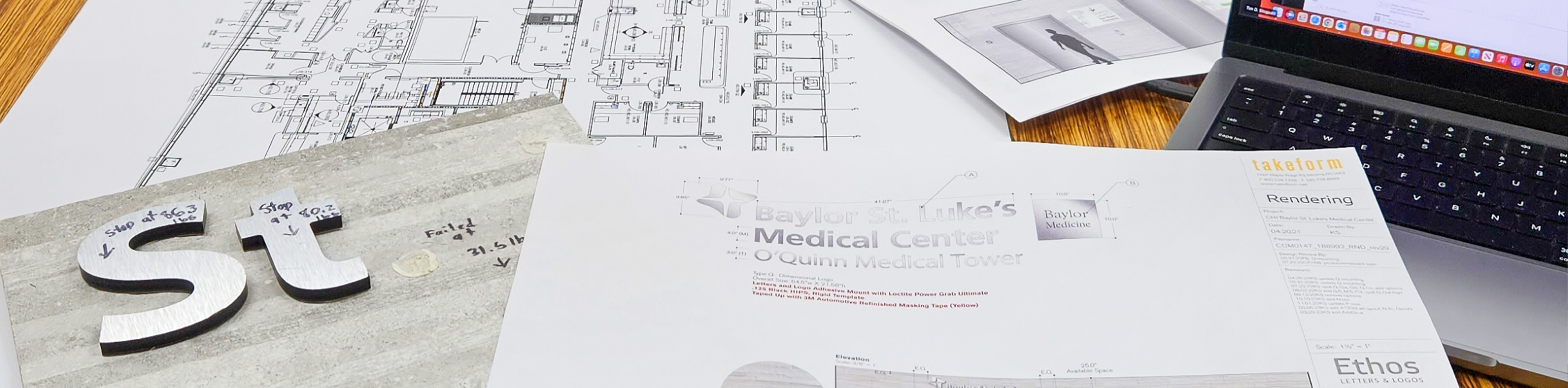 A project meeting setting with site surveys, renderings, and product testing on display.