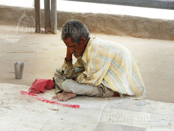 Old Man is Begging outside the Jain Temple.