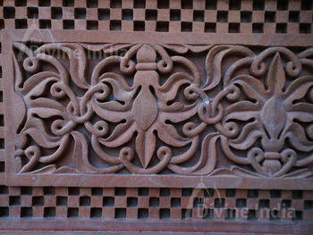 Wall sculpture from a stone in the form of a flower on walls