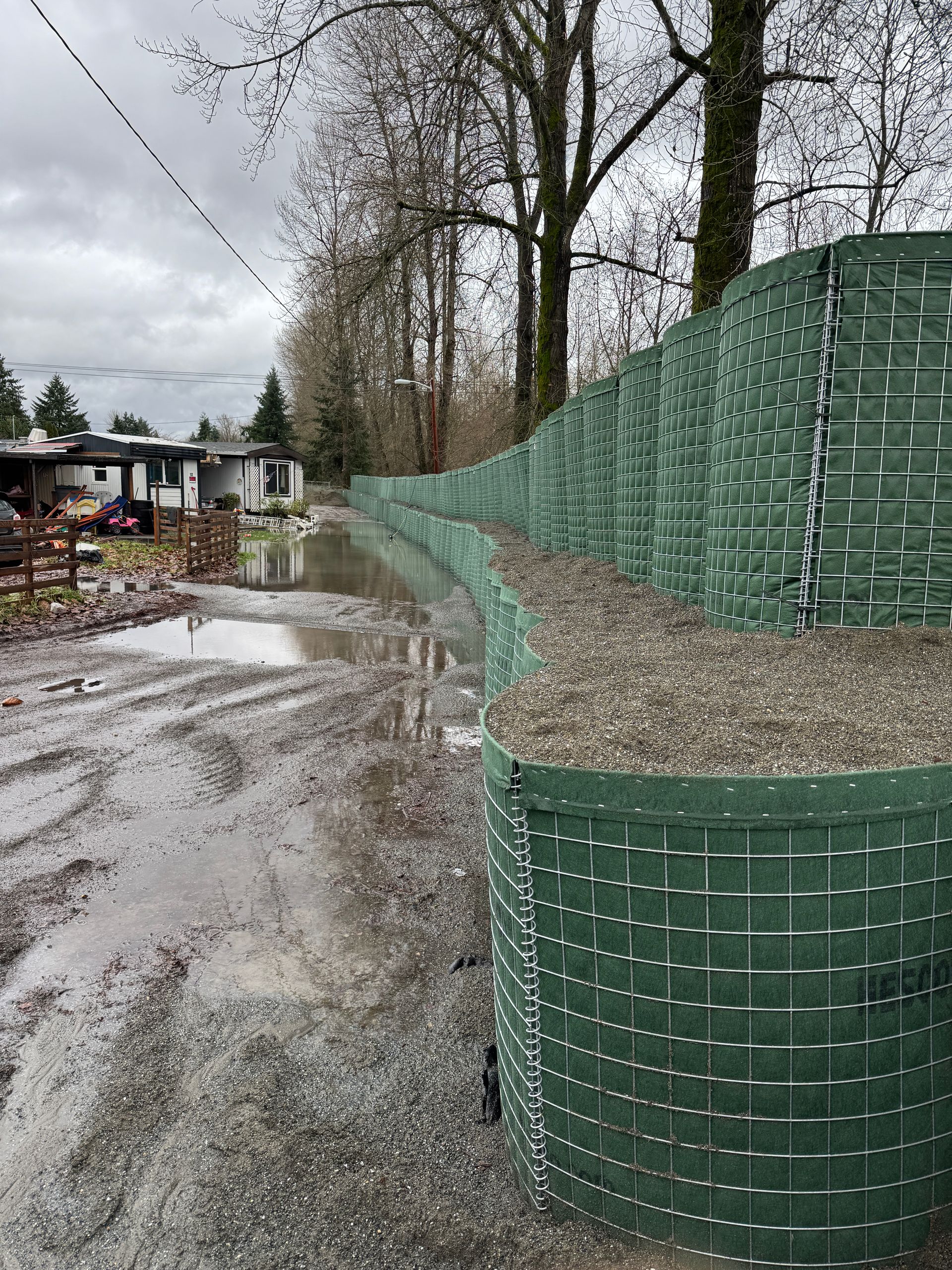 EBS MAC FE modular flood barrier units deployed on a riverbank