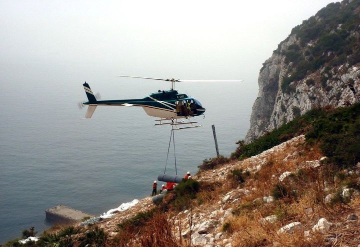Rolls of debris mesh being lifted to project site