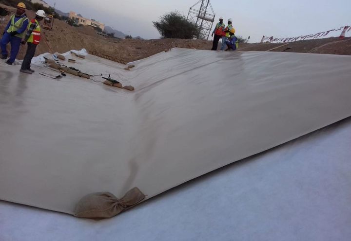 During construction: Beige colour HDPE geomembrane lining layer installation