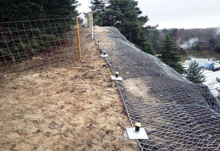 The top of the netting fastened by nailing into the soil structure