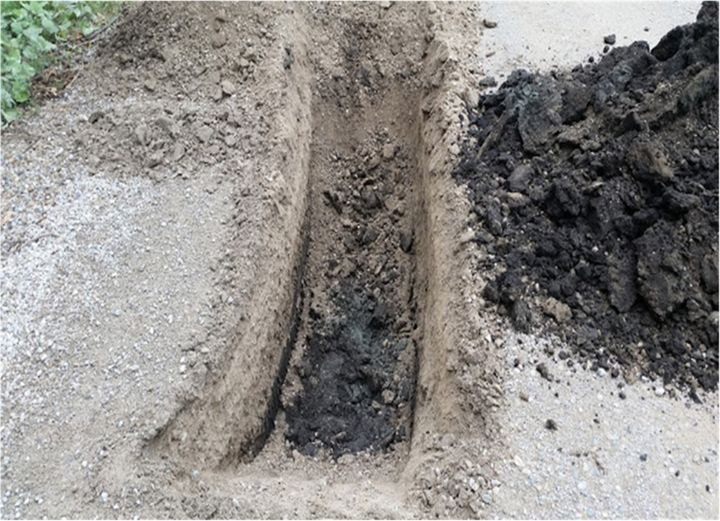 Detail of the black native soil at the base of the road 