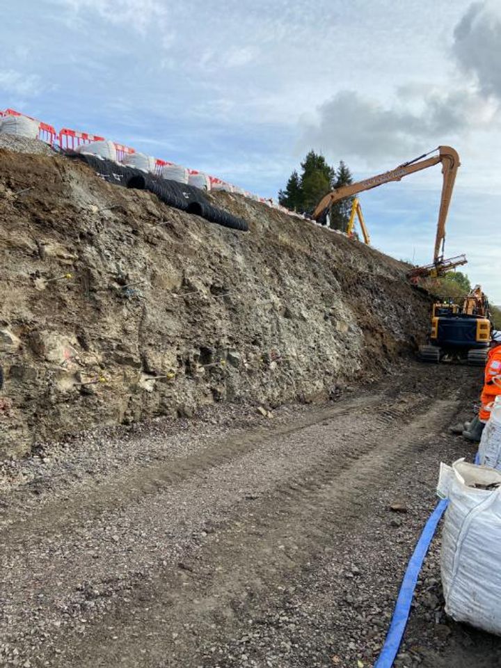 Soil nailing of the newly cut rock slope adjacent to the  rail line.
