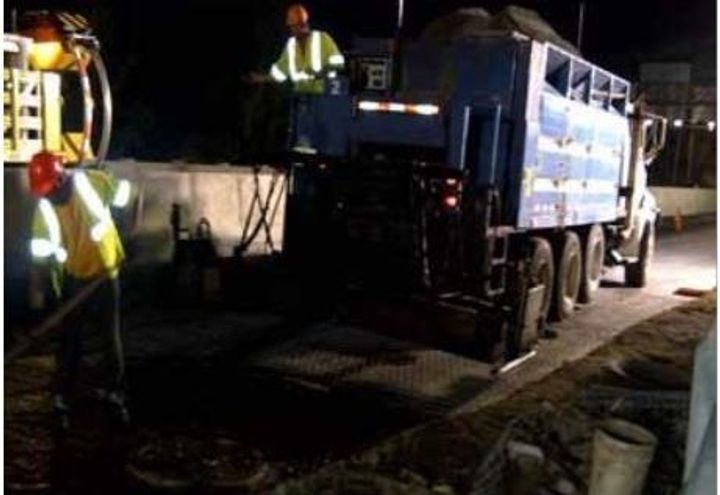Slurry seal being placed on top of roadmesh