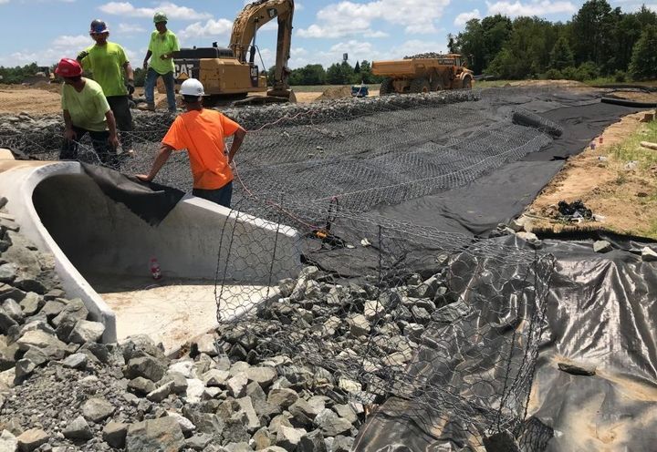 Gabion Mat being cut to fit next to concrete outlet structure