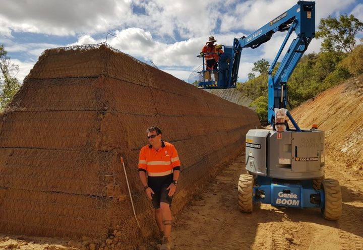 GTM embankment: Workers on EWP filling top most level of GTM cage