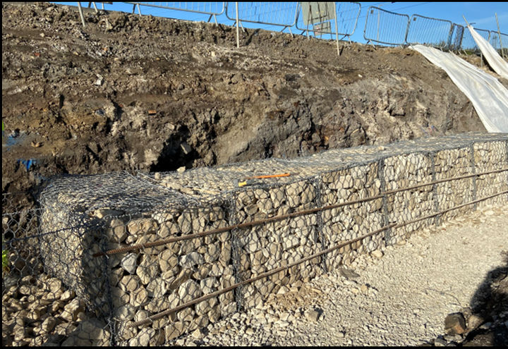 Gabion units laid out ready for filling - note highway above