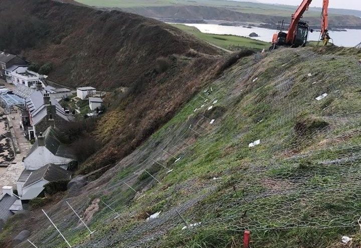 DT Rockfall netting being secured to the cliff slope.
