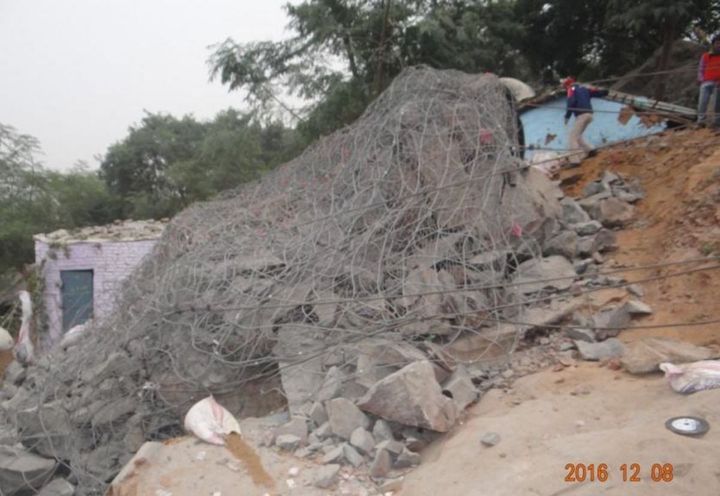 Figure 5- Boulder after blasting with mesh containing demolished fragments