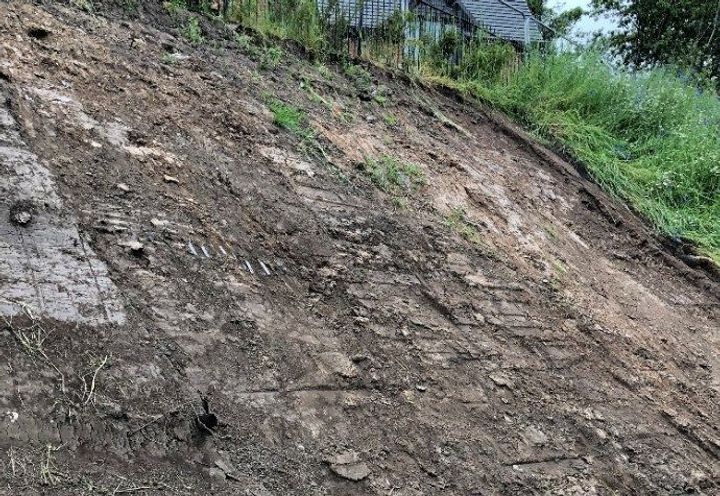 Slope face stripped of excess topsoil ahead of remedial works