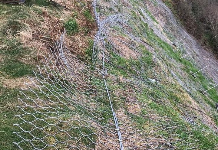 Installation of anchors and crest rope secure the DT netting.
