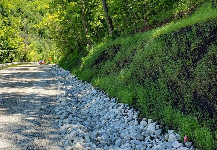 Finished road and upper side slope fully vegetated and protected with MacMat® R