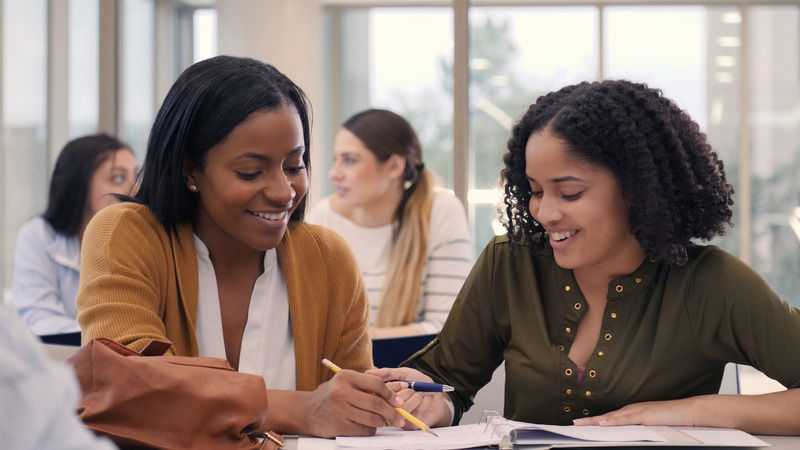 Smiling tutor helps eager college student