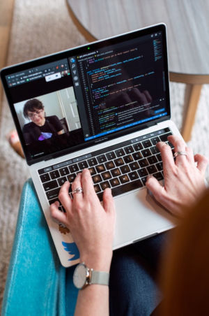 Close-up of a professional at work coding on a laptop, symbolizing Techlina's commitment to software excellence.