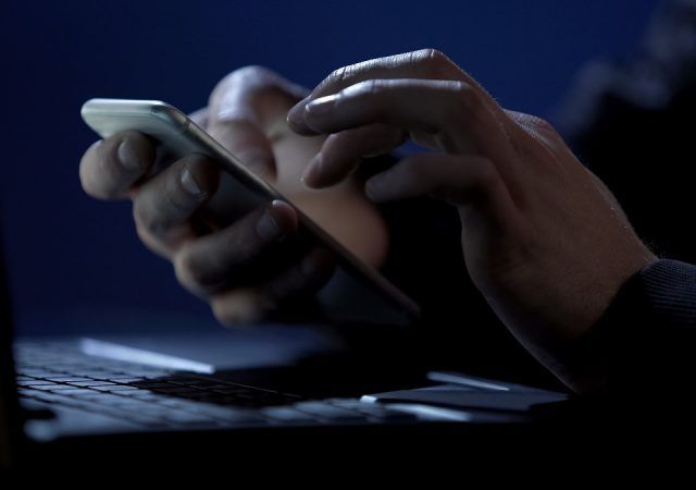 Scammer holds smartphone, cracks two-factor authentication, steals money online, stock footage