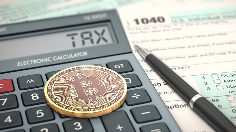 close-up view of a bitcoin coin, an electronic calculator and a tax form (3d render)