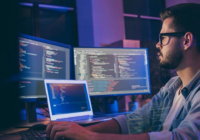 Profile side view portrait of his he nice attractive skilled smart focused, concentrated guy consultant writing script creating new digital desktop app in dark room workplace station indoors