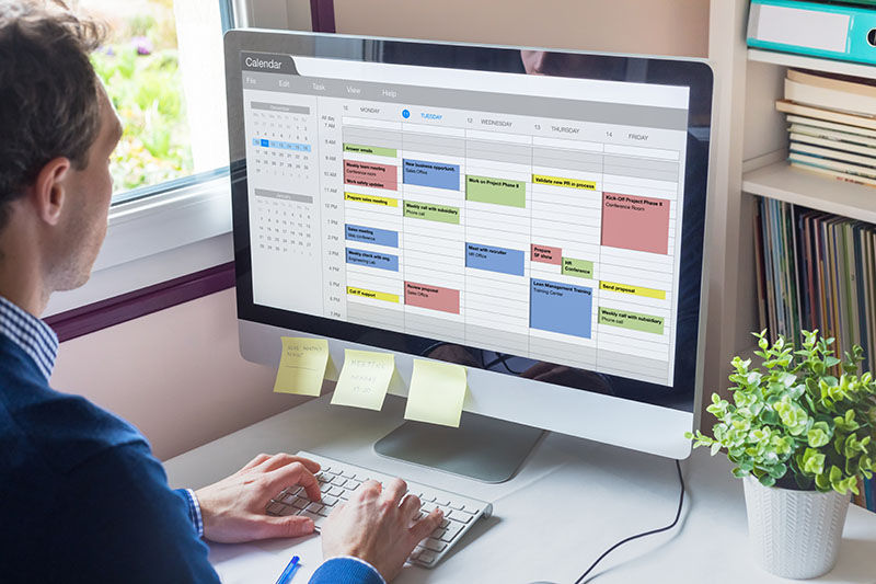 Calendar software showing busy schedule of manager with many meetings, tasks and appointments during the week, time management organization at work concept, business person using agenda on computer