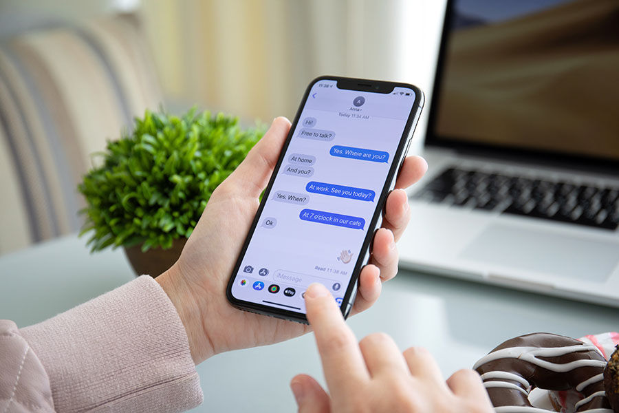 Alushta, Russia - September 28, 2018: Woman hand holding iPhone X with social networking service iMessage on the screen. iPhone 10 was created and developed by the Apple inc.