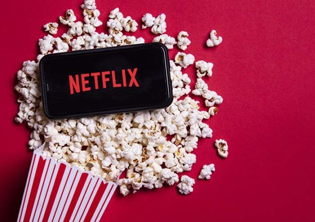 Netflix app on a phone on a bag of popcorn