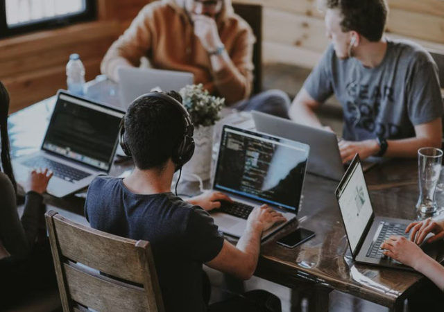 group of people using laptops and computers