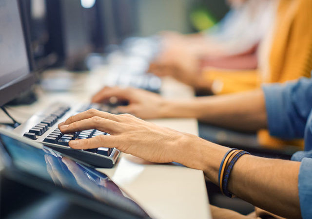 Row of Diverse Group of Multi-Ethnic People Works on PC. Office Team of Technical Support Staff Members Work on Computers, Help People Find Solutions. Camera Shot focus On Hands