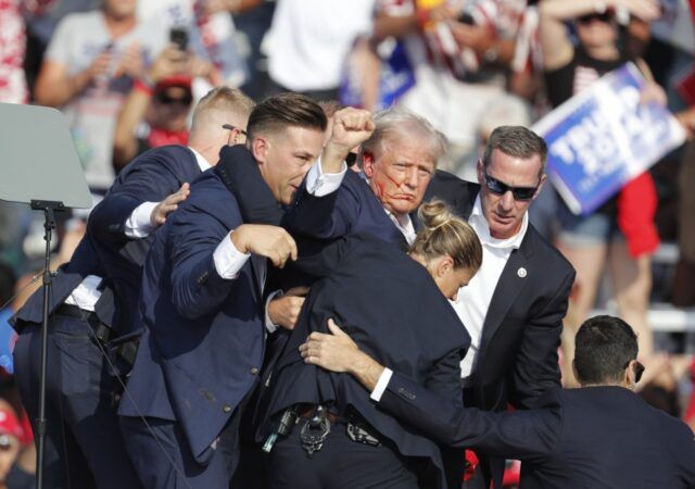 Former U.S. President Donald Trump is rushed off stage by Secret Service officers after being shot at during a campaign rally at the Butler Farm Show Inc. in Butler, Pennsylvania, U.S., July 13, 2024. (Image credit: EPA Photo)